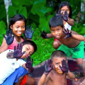 Huito Painting Children | Nomad Lodges | Plan South America